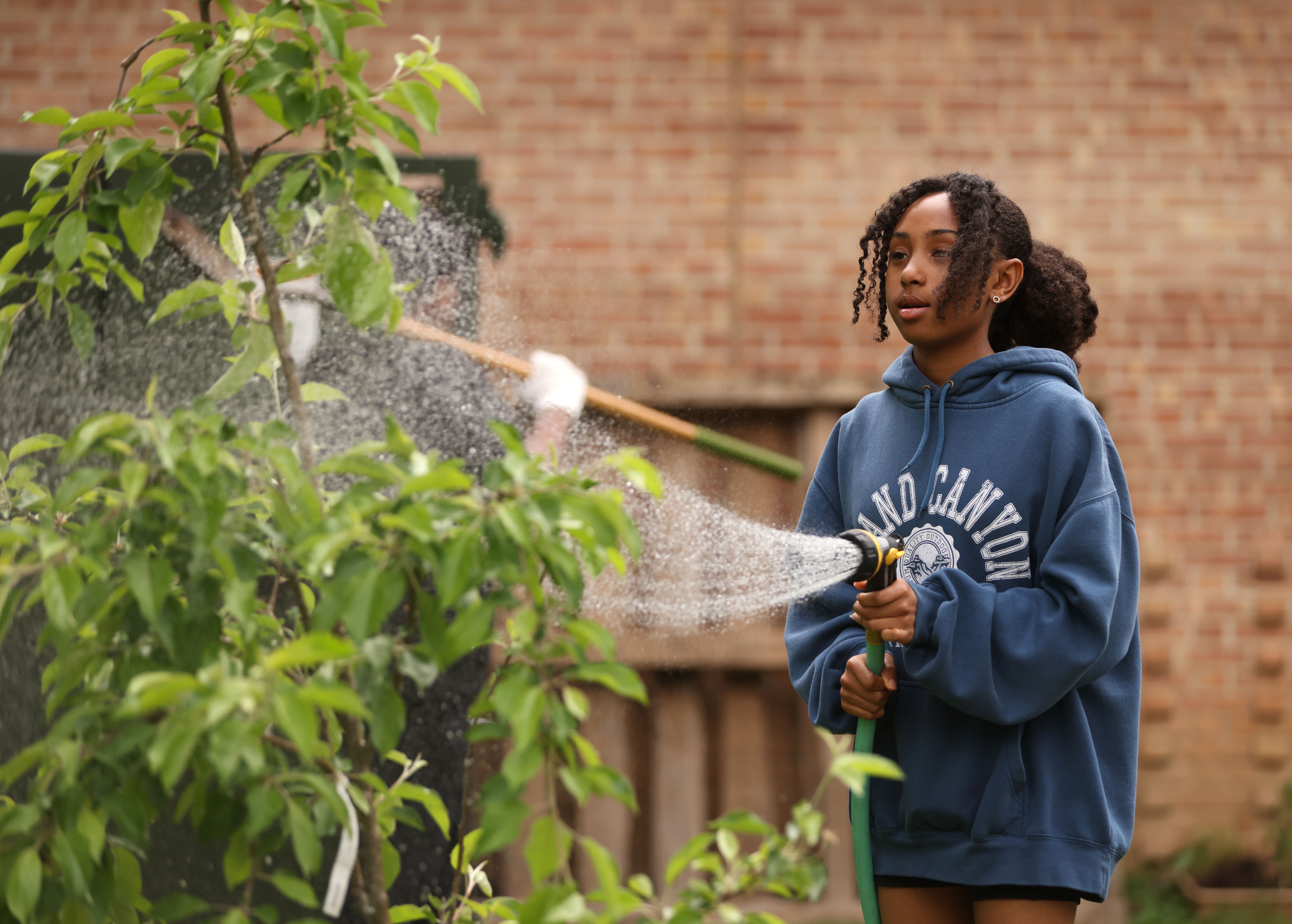 girl watering the garden